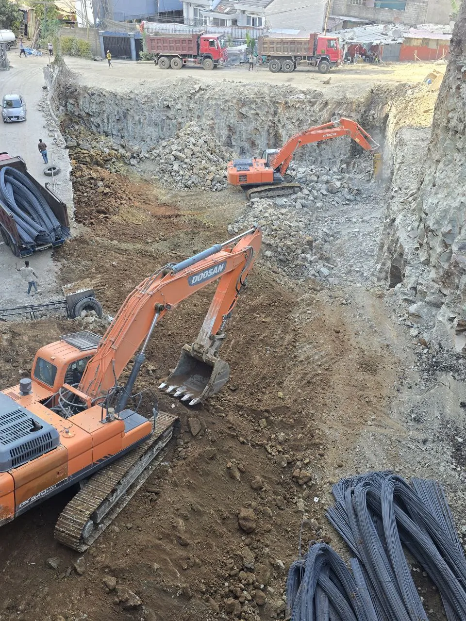 Excavators working on high-rise construction excavation